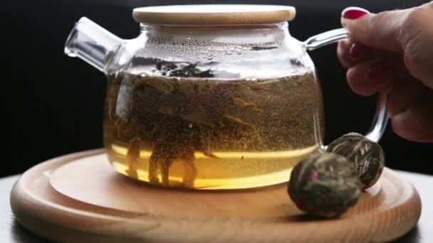 Female Hands Put Transparent Teapot Hot Herbal Tea Wooden Stand Stock-optagelser