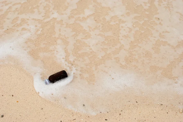 Flaska på stranden havet och våg — Stockfoto