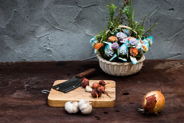 Chalotas, cebola, alho, tábua de corte e faca com flor — Fotografia de Stock