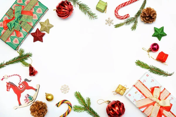 Christmas concept. Layout of New Years decor, toys, gifts and fir branches on a white background. Top view, copy space — Stock Photo, Image