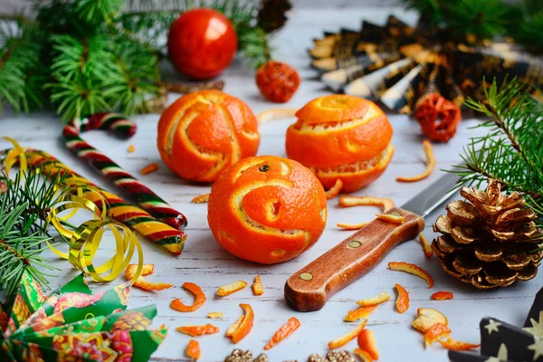 Carved tangerines in the form of Christmas balls on the background of Christmas decor. — Stock Photo, Image