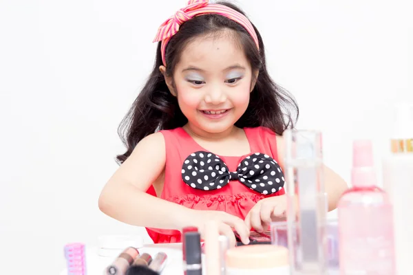 Little Asian child with makeup accessories — Stock Photo, Image