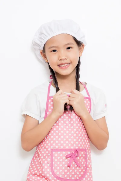 Little Asian cute chef wearing pink apron — Stock Photo, Image