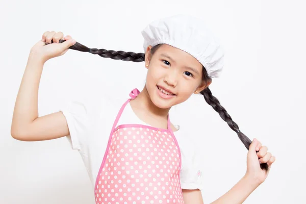 Kis-ázsiai aranyos chef visel rózsaszín kötény — Stock Fotó