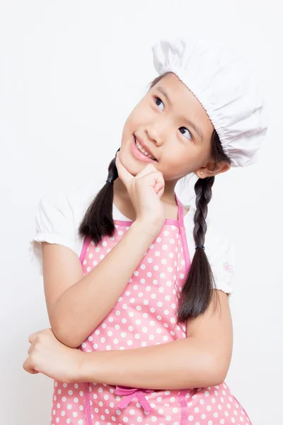 Little Asian cute chef wearing pink apron thinking action — Stock Photo, Image