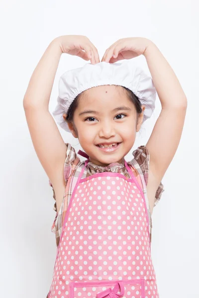 Kis-ázsiai aranyos chef visel rózsaszín kötény — Stock Fotó