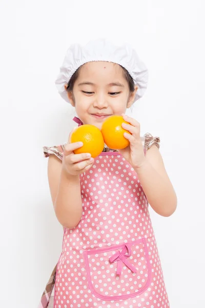 Happy little Asian cute chef wearing pink apron — Stock Photo, Image