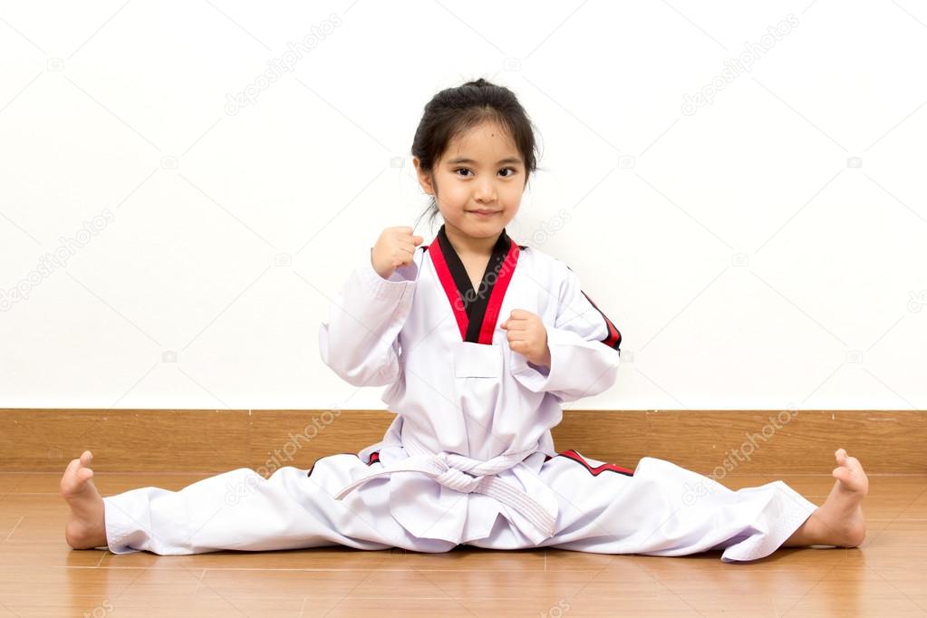 Little asian child in fighting action on isolated background