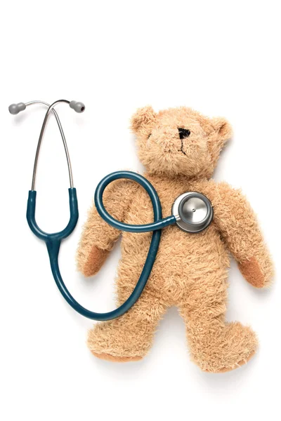 Bear doll and stethoscope on a white background — Stock Photo, Image