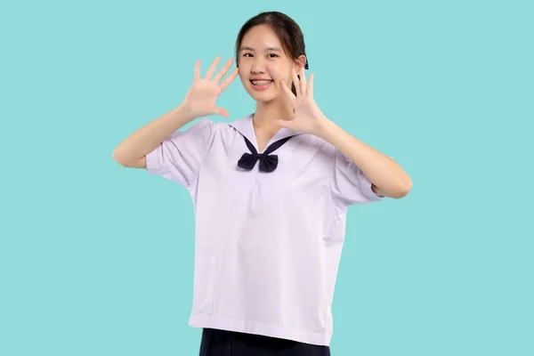 ハッピーブレースアジアの学生女の子で学校制服笑顔上の隔離されたパステルの背景 — ストック写真