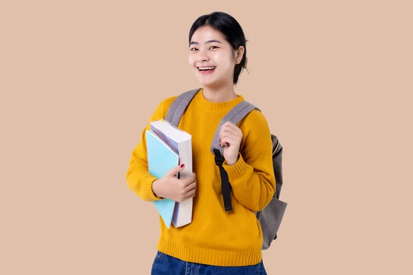 Young Asian Student Girl Holding Books Backpack Isolated Background — Stock Photo, Image