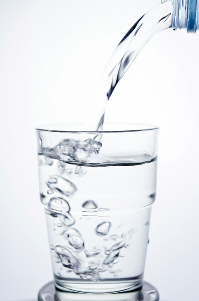 Filling a glass with water showing a drink concept