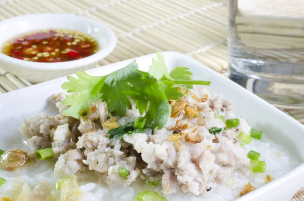 Soft-boiled rice pork with Glass of water and fish sauce — Stock Photo, Image