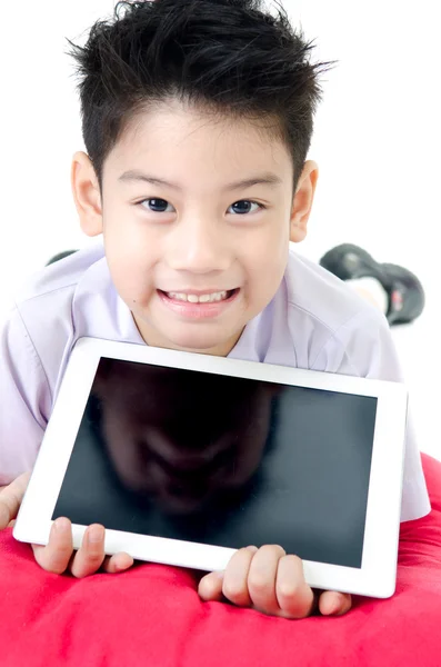 Little asian boy in student's uniform with tablet computer on is — Stock Photo, Image