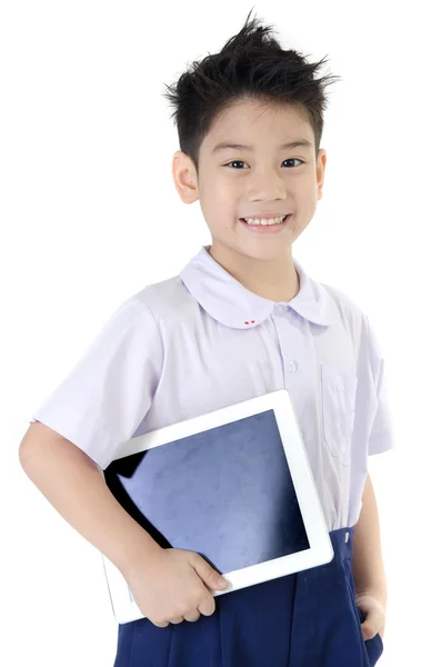Little asian boy in student's uniform with tablet computer on is — Stock Photo, Image