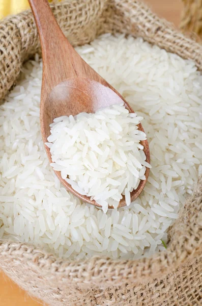 Wooden spoon with raw rice — Stock Photo, Image