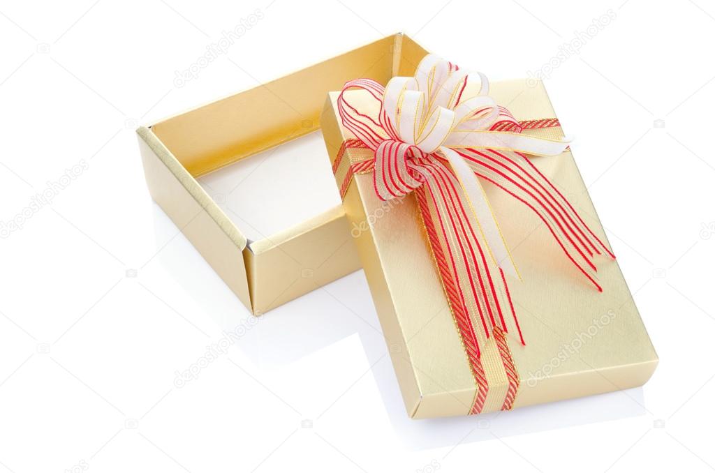 Gold present gift box with overwhelming bow isolated on white