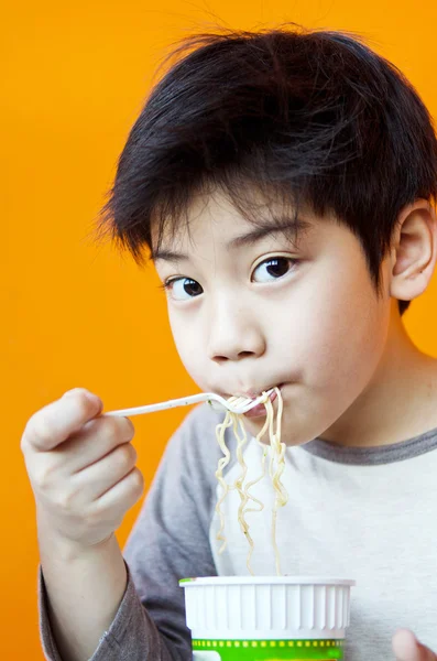 Asian cute boy with noodle cup — Stock Photo, Image