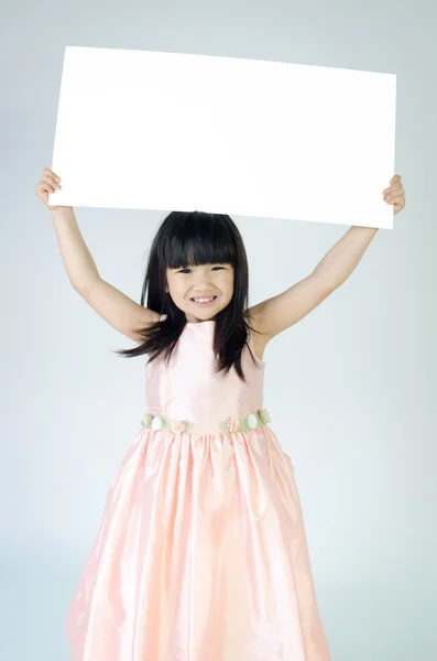 Portrait of young Asian girl holding blank billboard — Stock Photo, Image