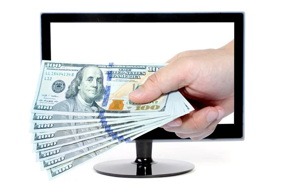 Mão com dinheiro vem da tela do monitor do computador — Fotografia de Stock