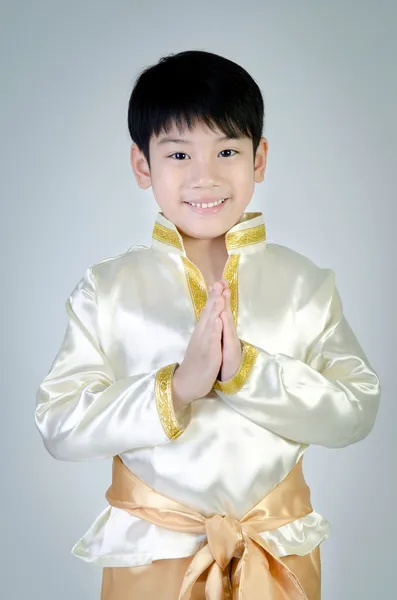 Asian cute boy in thai costume acting Hello in thai on gray back — Stock Photo, Image