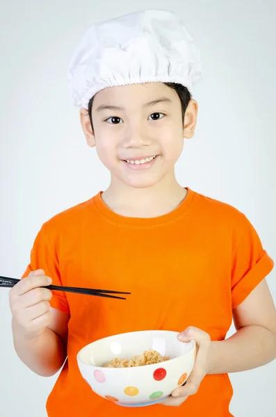 Asian cute child eating ramen noodles in ceramic bowl . — Stock Photo, Image