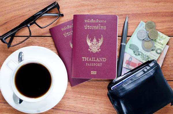 Thailand Passport with currency on teak wood . — Stock Photo, Image