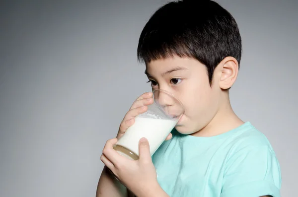 Portrait of Little asian boy drinking a glass of milk — Stock Photo, Image