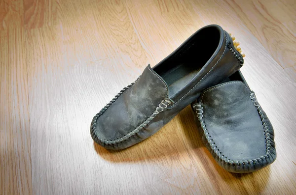 Dirty Shoes vintage style on wood floor — Stock Photo, Image