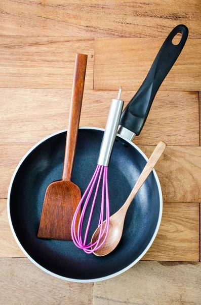 Nahaufnahme von eisernen Pfannen und hölzernen Utensilien — Stockfoto