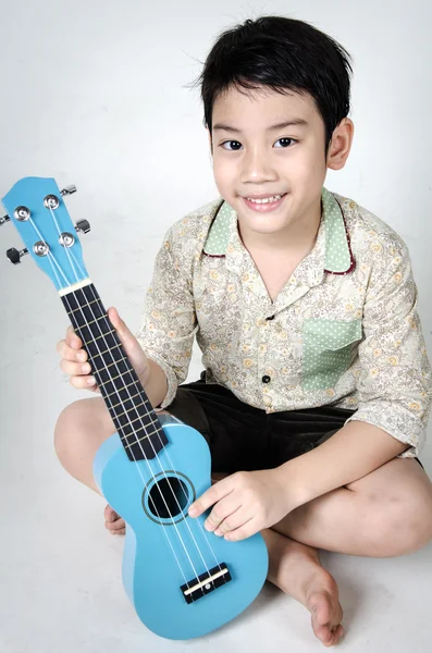 Asian child  with his ukulele — Stock Photo, Image