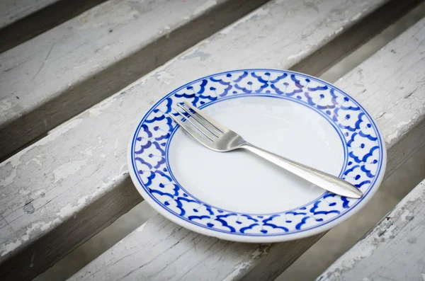 Fork on vintage empty plate — Stock Photo, Image