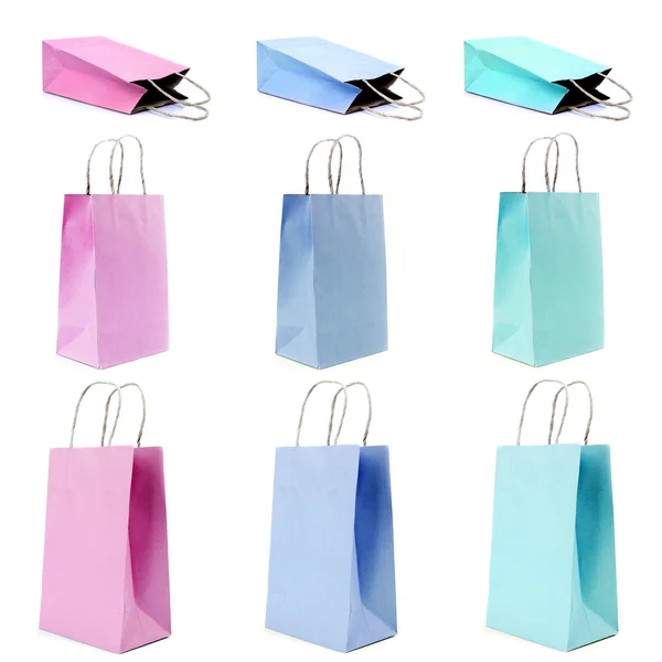 Nine empty shopping paper bags in pastel colors. — Stock Photo, Image