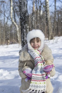 Little girl throws snow clipart