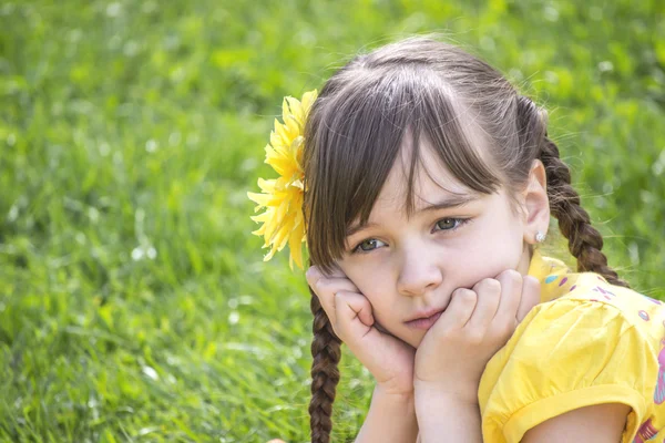 Little girl sad looks and thinks — Stock Photo, Image
