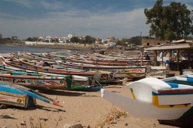 Fishing boats and a man sleeping on one of them.