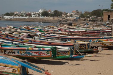 Fishing boats and a man sleeping on one of them.