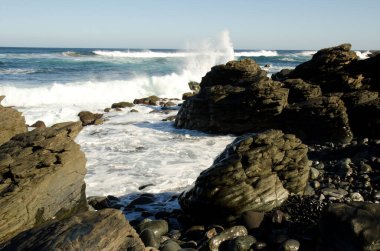 Waves breaking against the rocks in a coastal landscape. Quintanilla. Arucas. Gran Canaria. Canary Islands. Spain.