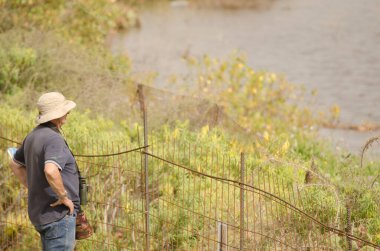 Birdwatcher and photographer by a lagoon. San Lorenzo. Las Palmas de Gran Canaria. Gran Canaria. Canary Islands. Spain.