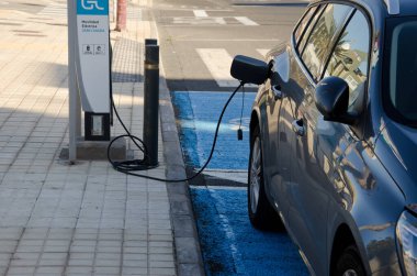 Playa de Arinaga, March 3, 2021: Electric car in a charging station. Aguimes. Gran Canaria. Canary Islands. Spain.