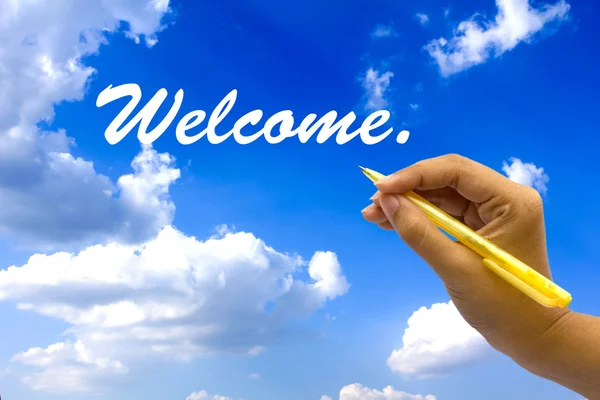 Hand writing welcome on blue sky. — Stock Photo, Image