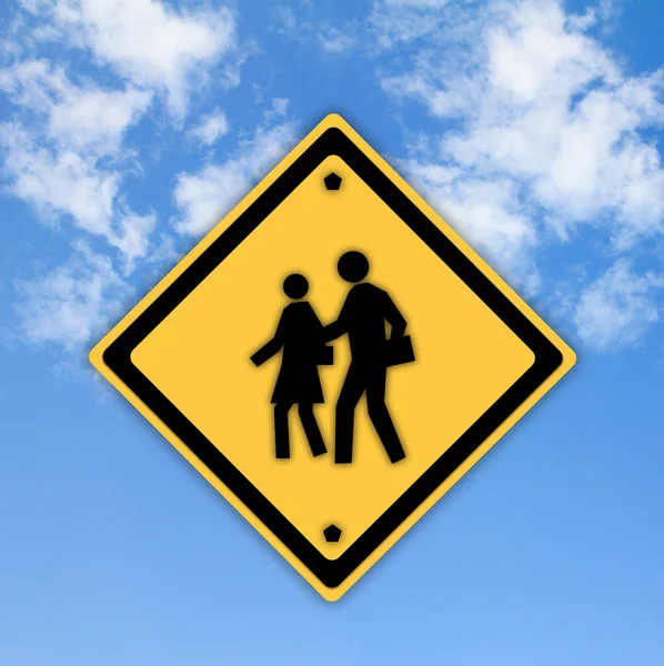 Шкільний знак попередження на жовтому фоні з блакитним небом — стокове фото