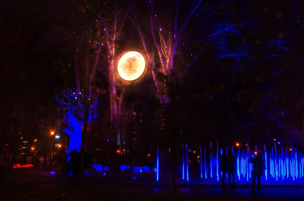 Illumination in the park, illumination of various installations, fantasy on the theme of light Stock Photo