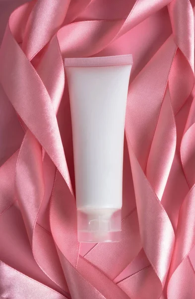 Cosmetic Cream Tube Packaging Silk Ribbon Pastel Pink Background Beauty — Stockfoto