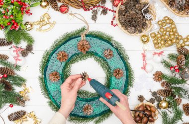 Büyük bir Noel çelengi yapmak adım adım, beşinci adım - çam kozalaklarını sıcak yapıştırmak