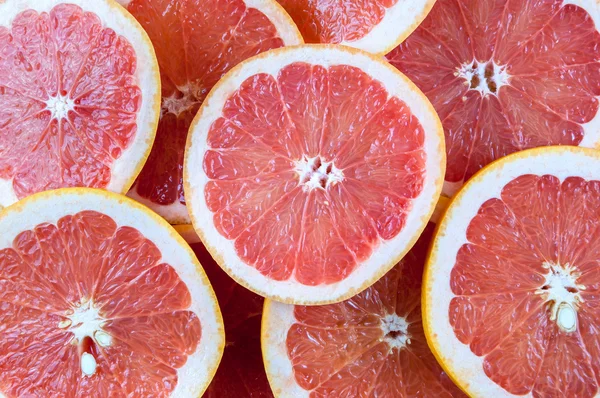Pozadí červeného grapefruitu řezů — Stock fotografie