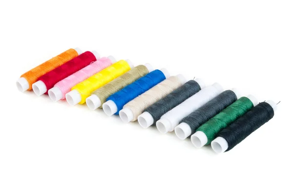 Colored spools of threads in a row — Stock Photo, Image