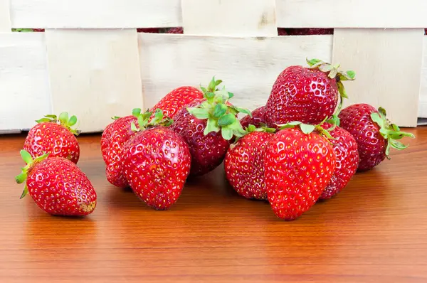 Strawberries in front of a basket — Stock Photo, Image