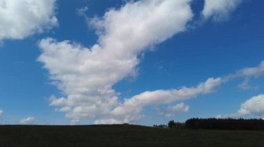 Time-lapse blue sky, billowing white clouds, beautiful sunny day, green forest. Rainy Clouds Over Rural Landscape With Young. Stock Video