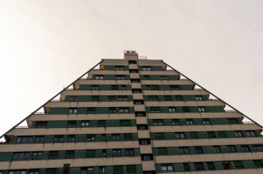 pyramid-shaped residential building on a cloudy day